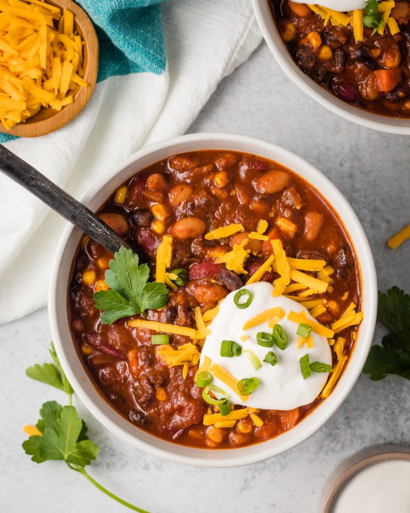A great vegan pantry recipe – Vegan chili topped with vegan sour cream and cheese.
