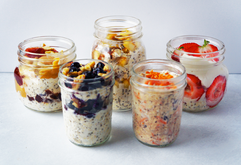 Jars of overnight oats on a white table.
