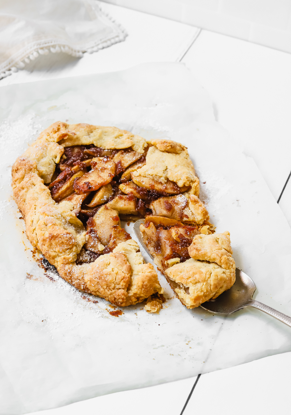 Delicious and crisp apple pie galette with a slice taken out. 