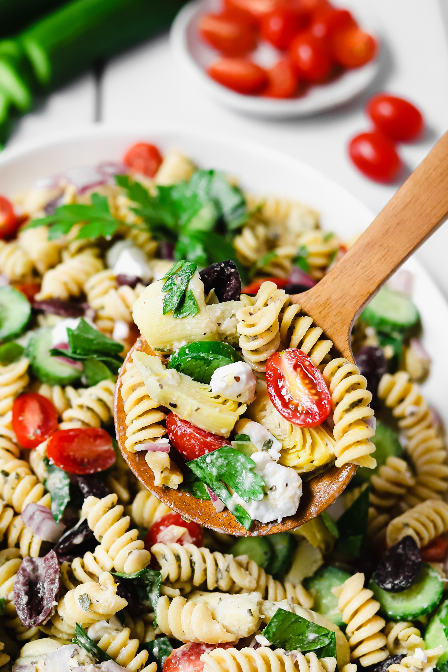 A large spoon full of vegan greek pasta salad